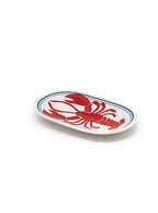 White oval-shaped trinket tray with lobster  print on a white background.