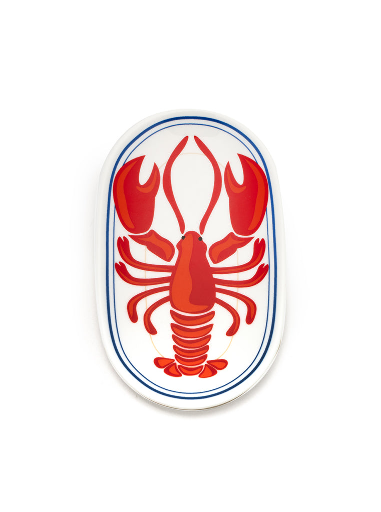 White oval-shaped trinket tray with lobster print on a white background.