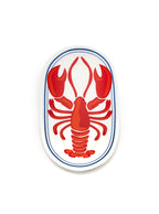 White oval-shaped trinket tray with lobster print on a white background.