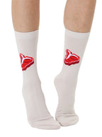 White socks with red steak print worn by a person on a white background