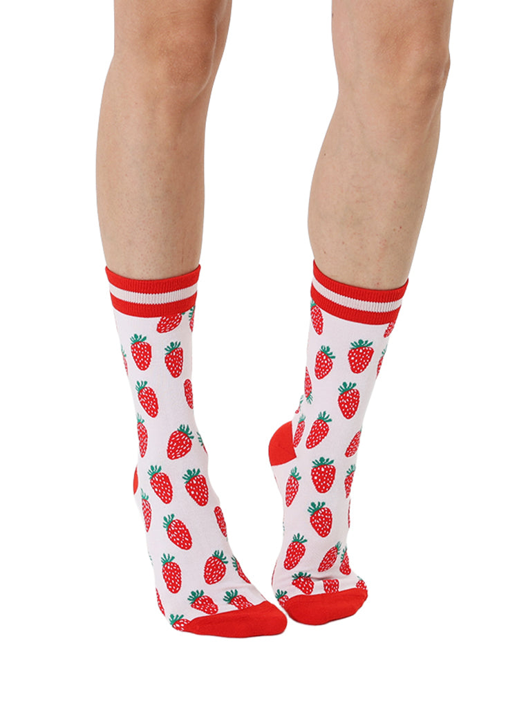 Red and light pink women’s bamboo crew socks featuring a strawberry-themed pattern, shown worn on a person against a white background.
