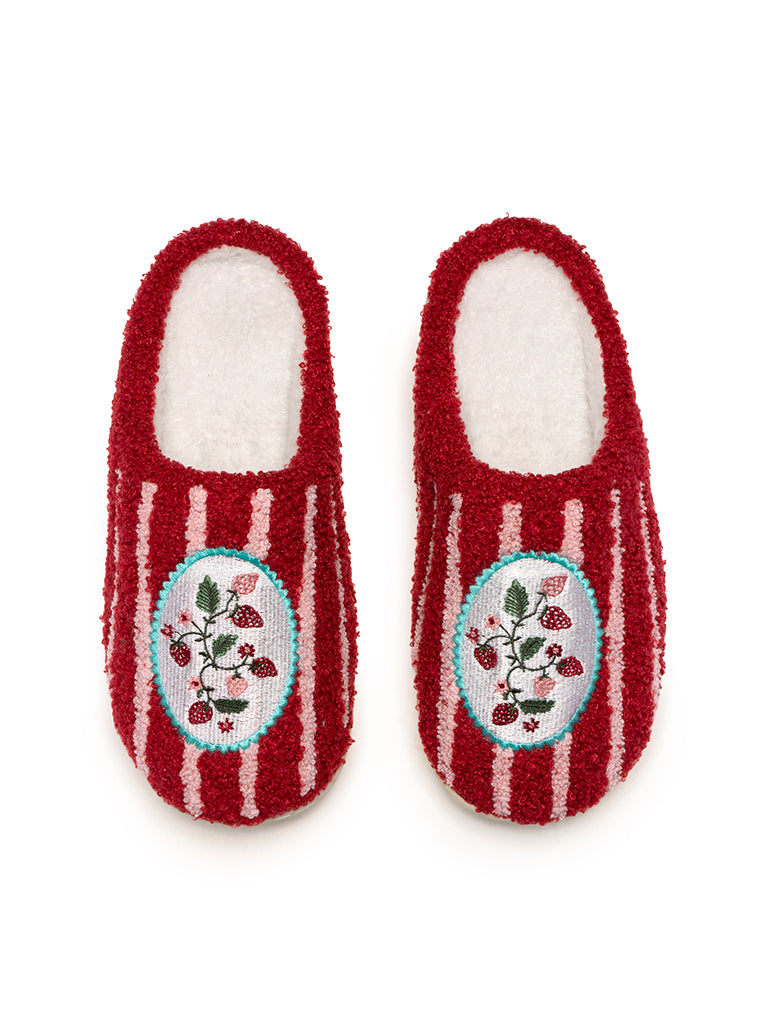 Pair of red slippers with white stripes and strawberry design on a white background