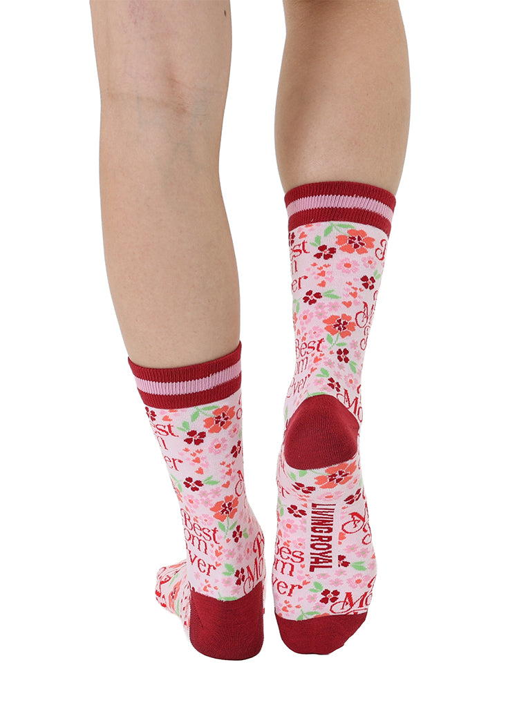 Pink and red women’s bamboo crew socks featuring a “Best Mom Ever” print with a floral pattern, shown worn on a person against a white background.