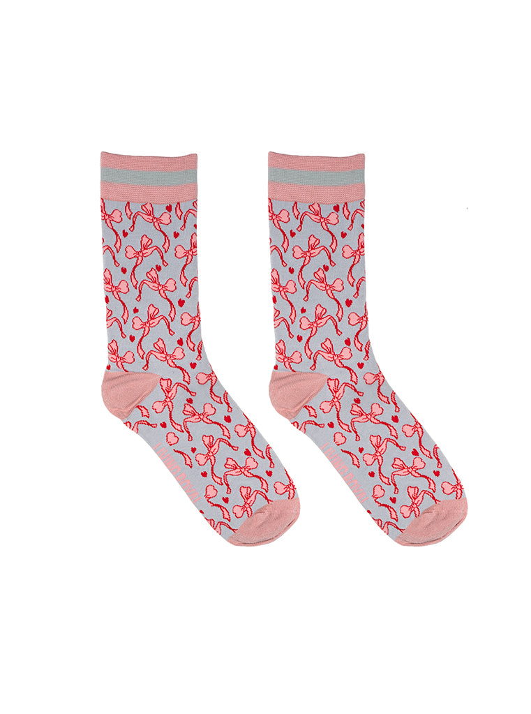 Pink and grey women’s bamboo crew socks featuring a delicate bow pattern print, shown on a white background.