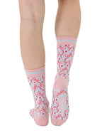 Pink and grey women’s bamboo crew socks featuring a delicate bow pattern print, shown worn on a person against a white background.