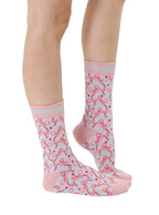 Pink and grey women’s bamboo crew socks featuring a delicate bow pattern print, shown worn on a person against a white background.
