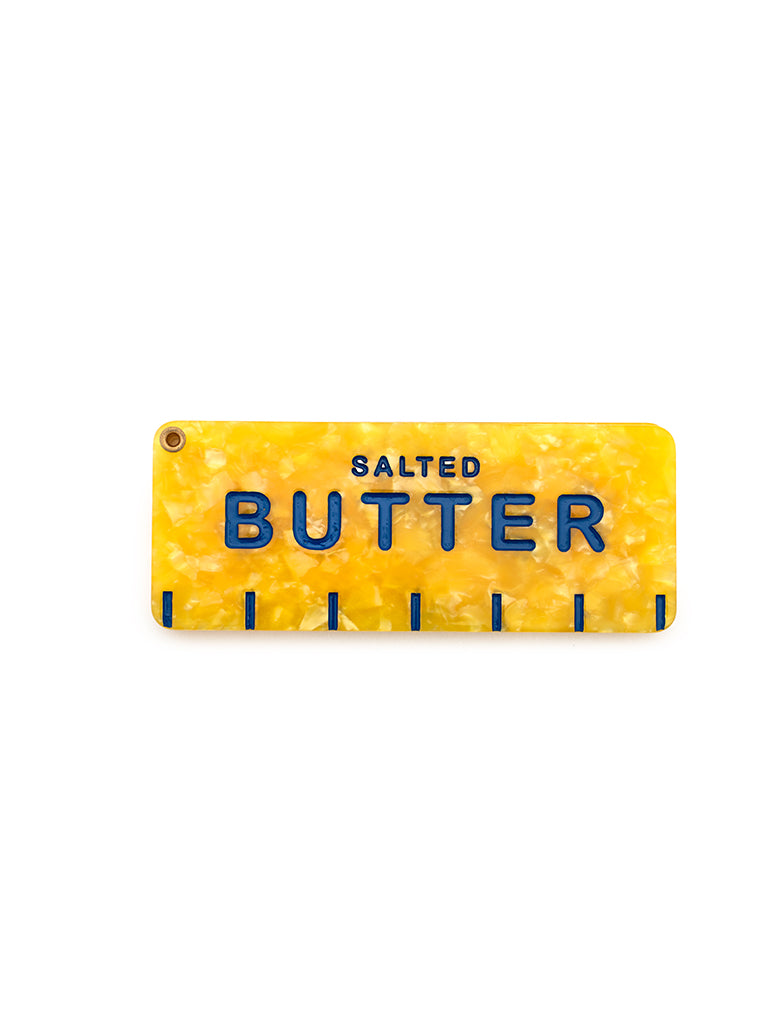 Yellow compact mirror featuring a salted butter print, perfect for on-the-go touch-ups, displayed on a white background.