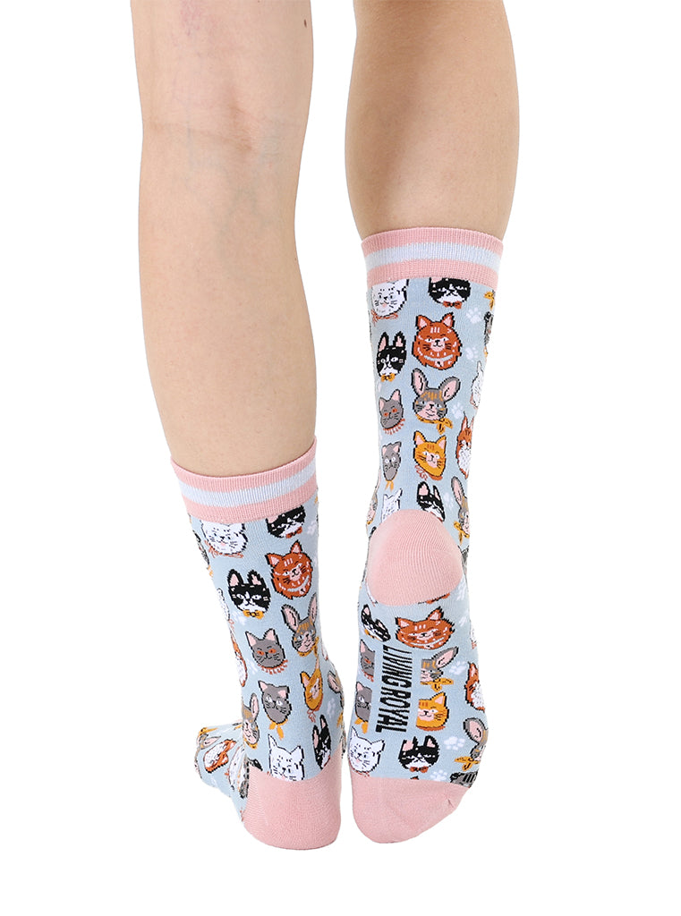Women’s bamboo crew socks featuring a variety of cat face–themed patterns, shown worn on a person against a white background.