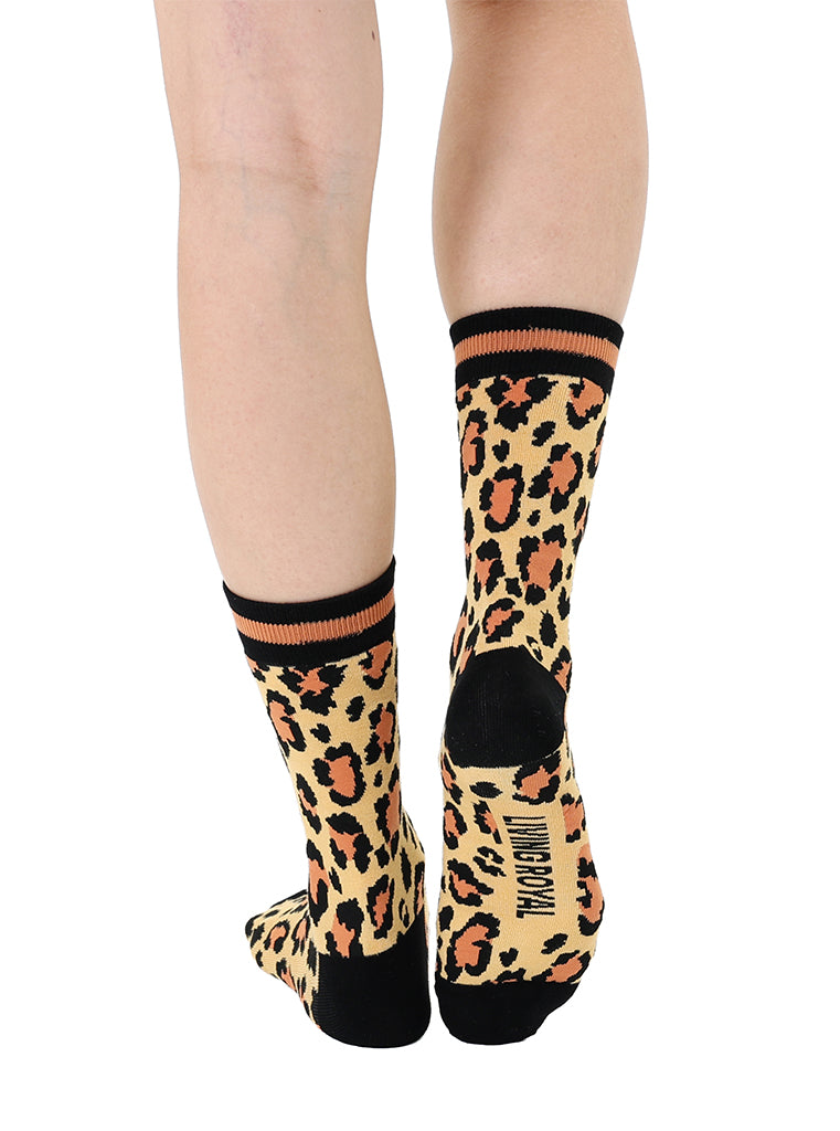 Women’s bamboo crew socks with a cheetah print pattern, shown worn on a person against a white background.