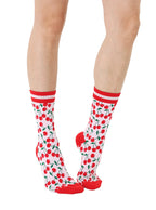 Red and light pink women’s bamboo crew socks featuring a cherry-themed pattern, shown worn on a person against a white background.