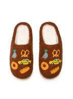 Brown slippers with cartoon designs on a white background