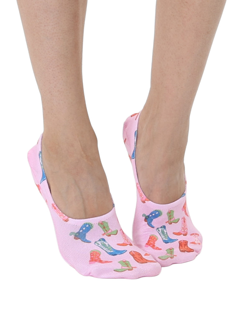 Pink socks with cowboy boots print worn by a person on a white background