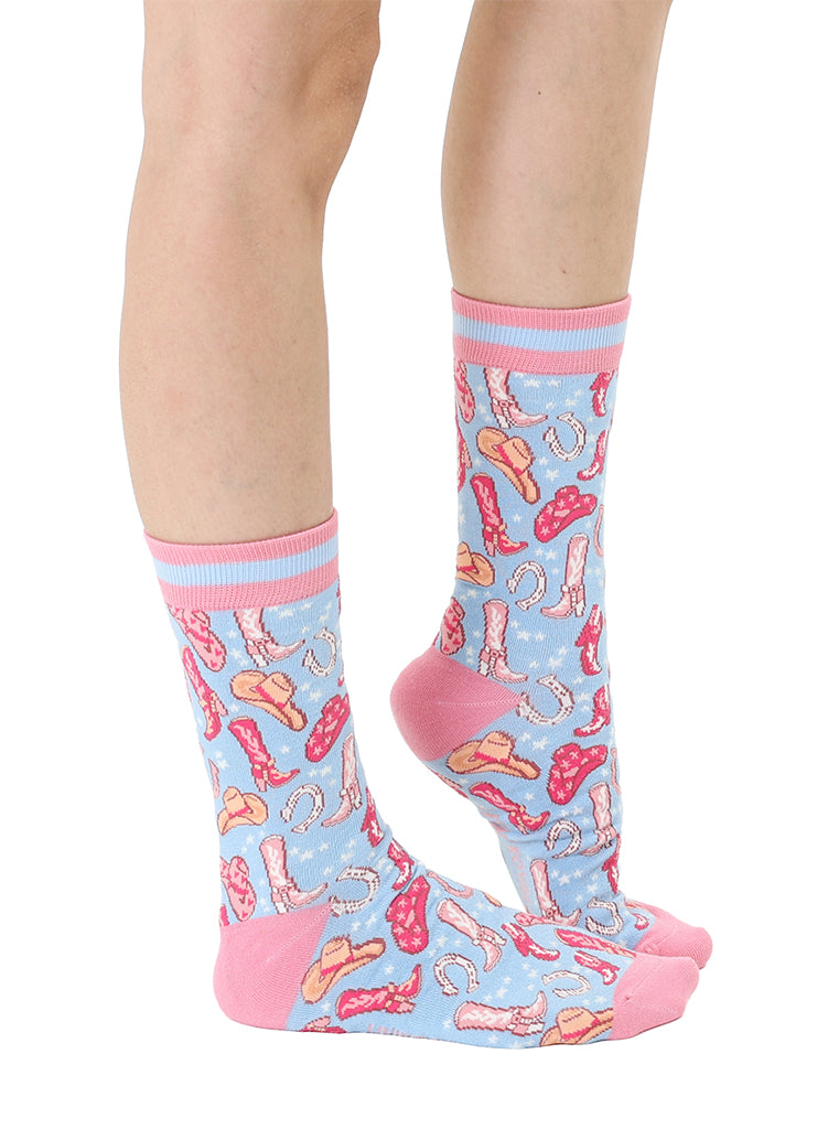 Pink and light blue women’s bamboo crew socks featuring a playful cowboy-themed pattern, shown worn on a person against a white background.