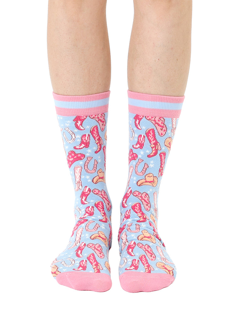 Pink and light blue women’s bamboo crew socks featuring a playful cowboy-themed pattern, shown worn on a person against a white background.