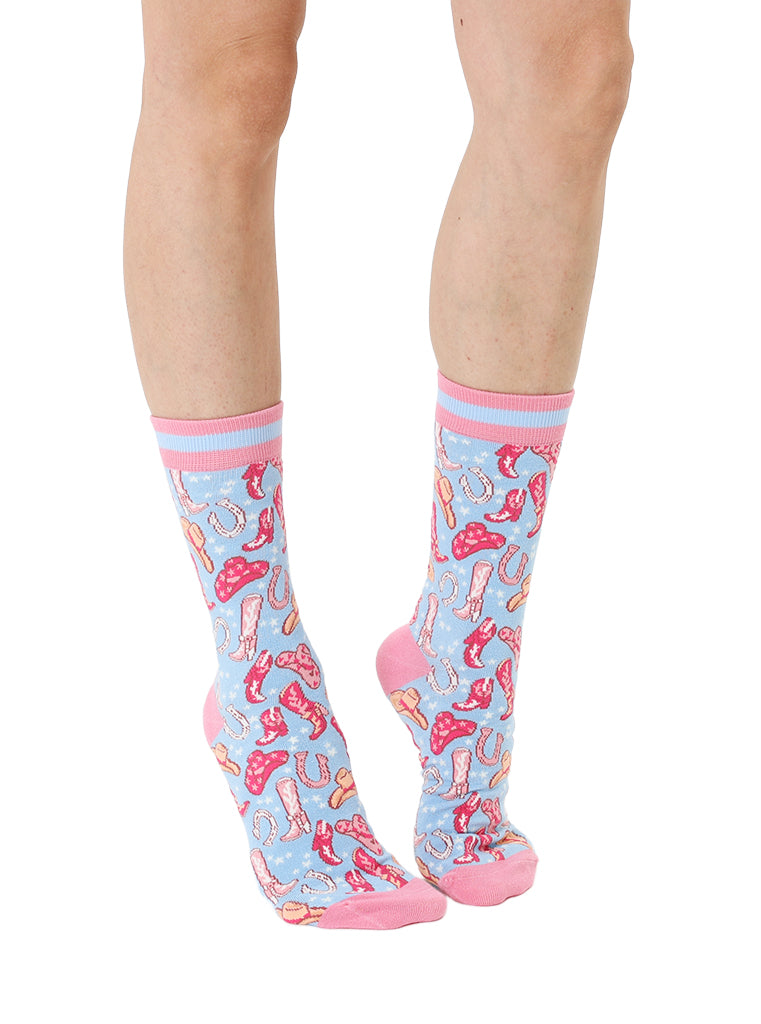 Pink and light blue women’s bamboo crew socks featuring a playful cowboy-themed pattern, shown worn on a person against a white background.