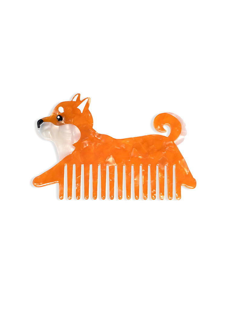 Hair comb featuring an orange dog design, displayed on a white background.
