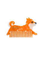 Hair comb featuring an orange dog design, displayed on a white background.