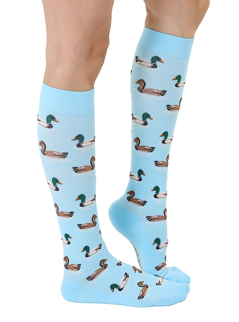 Lightblue padded compression socks featuring a white and brown ducks pattern, shown worn on a white background.