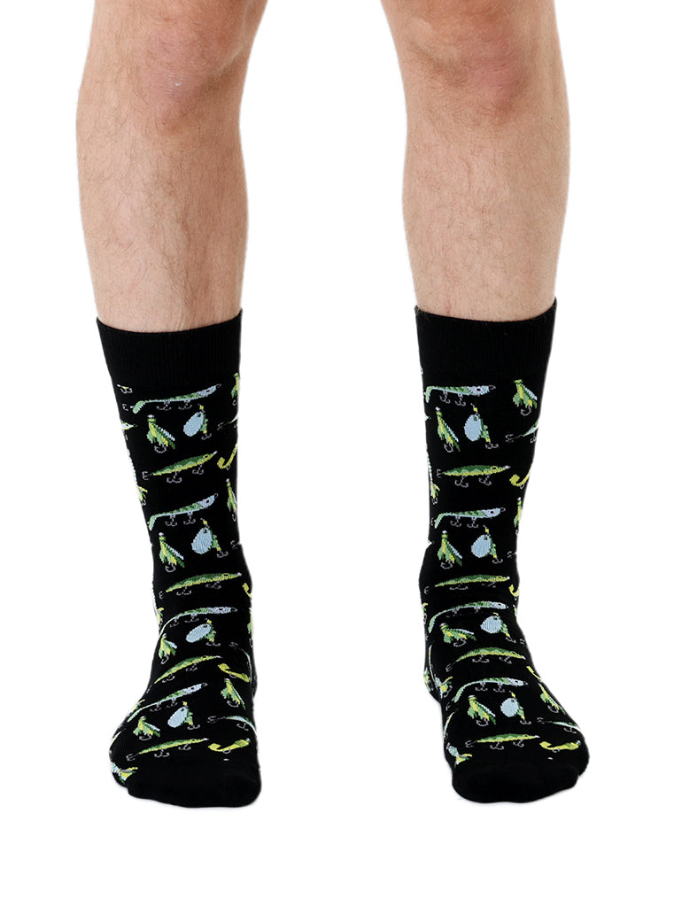 Black Men’s Bamboo Crew Socks with a fun fishing lure pattern. Worn on a crisp white background.