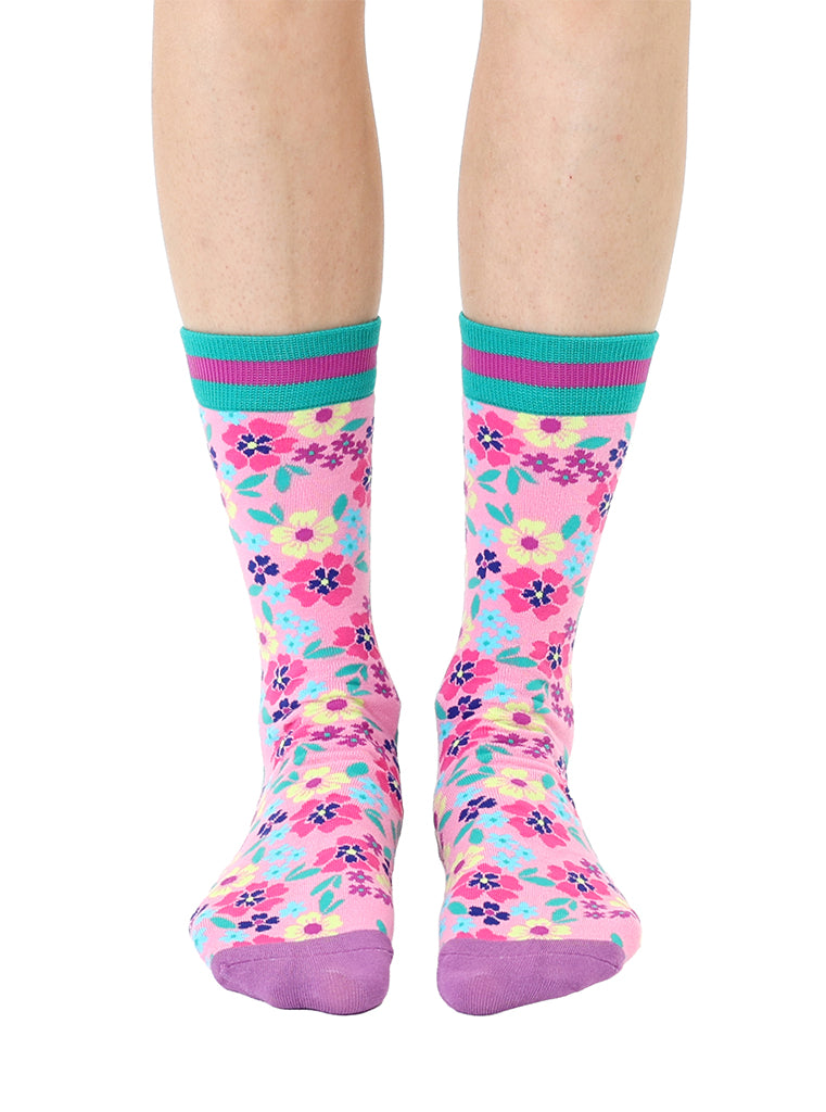 Light purple women’s bamboo crew socks with a vibrant floral pattern, shown worn on a person against a white background.