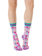 Light purple women’s bamboo crew socks with a vibrant floral pattern, shown worn on a person against a white background.
