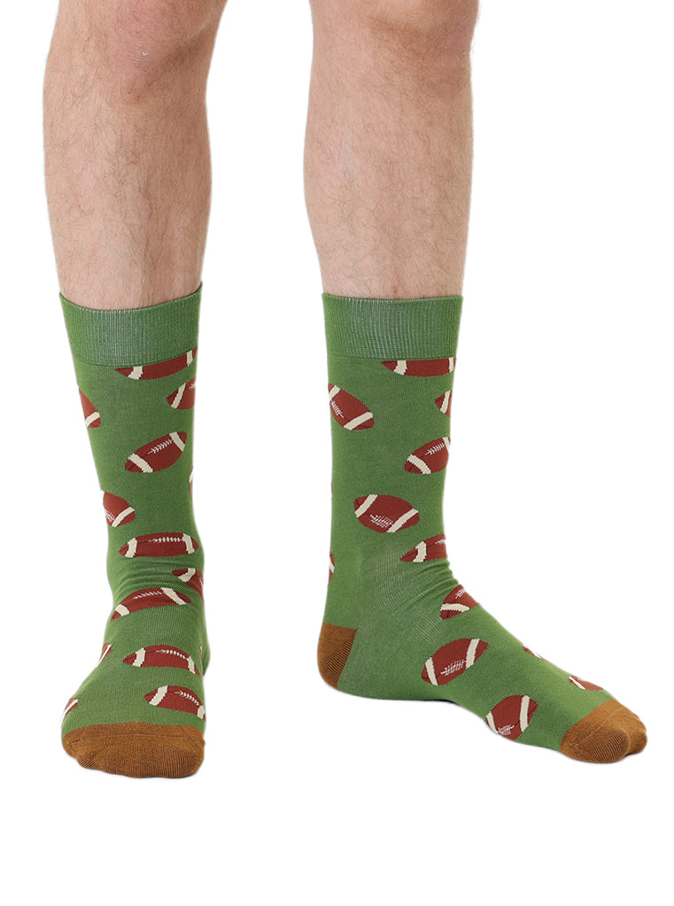 Green men’s bamboo crew socks featuring a football print, worn on a white background.
