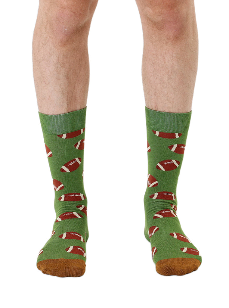 Green men’s bamboo crew socks featuring a football print, worn on a white background.