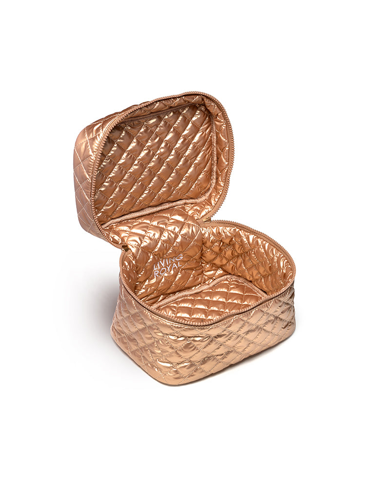 Gold cosmetic travel case display on a white background 