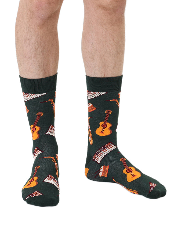 Dark green men’s bamboo crew socks featuring a musical instruments pattern, shown worn on a white background.