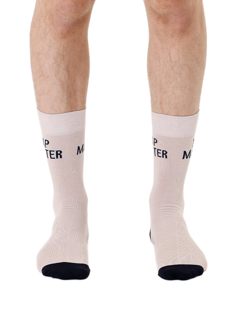 Beige men’s bamboo crew socks featuring a “Nap Master” slogan, shown worn on a white background.