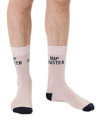 Beige men’s bamboo crew socks featuring a “Nap Master” slogan, shown worn on a white background.