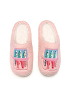 Pair of pink slippers with colorful text on a white background