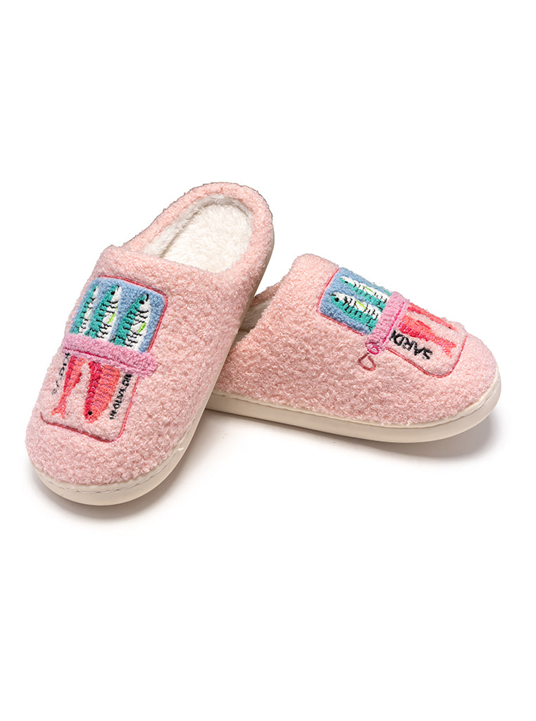 Pink slippers with colorful labels on a white background