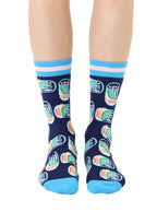Blue women’s bamboo crew socks featuring a sardines can print, worn by a person on a white background