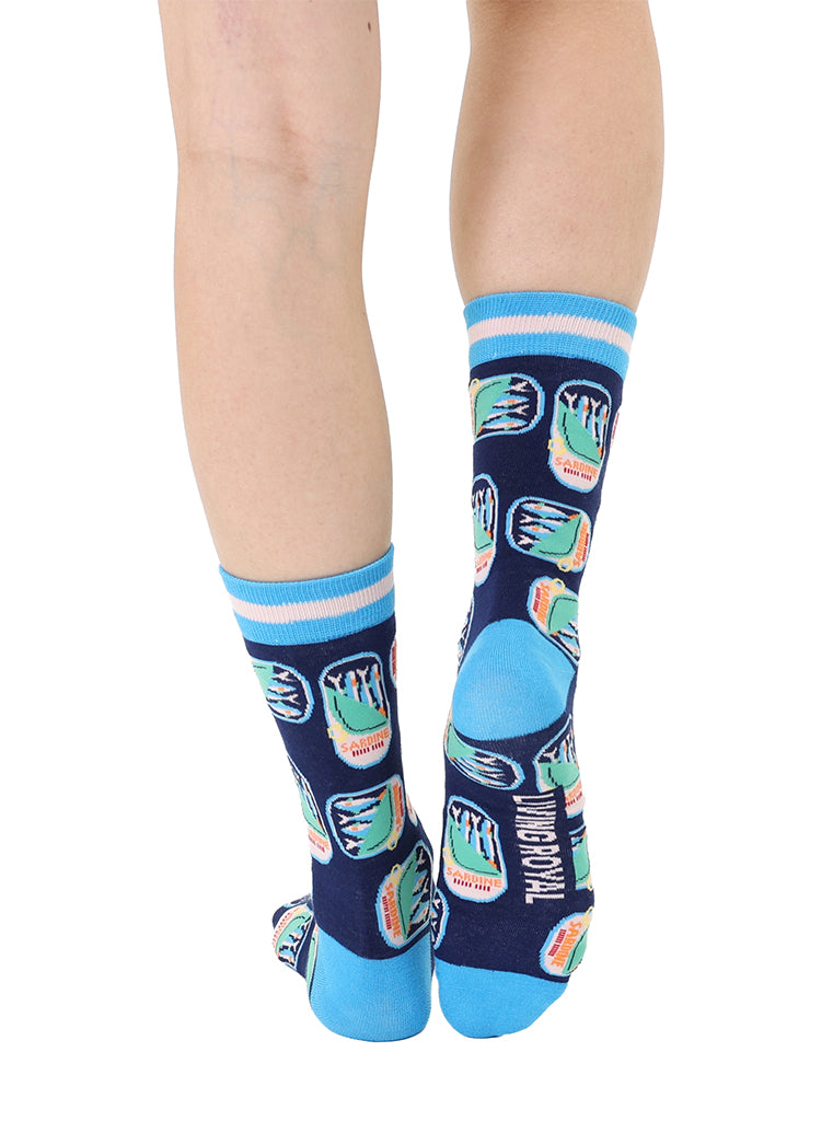 Blue women’s bamboo crew socks featuring a sardines can print, worn by a person on a white background