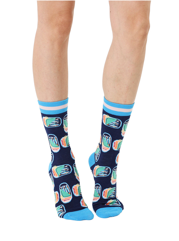 Blue women’s bamboo crew socks featuring a sardines can print, worn by a person on a white background
