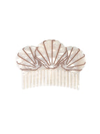 Hair comb featuring a seashell design, displayed on a white background.