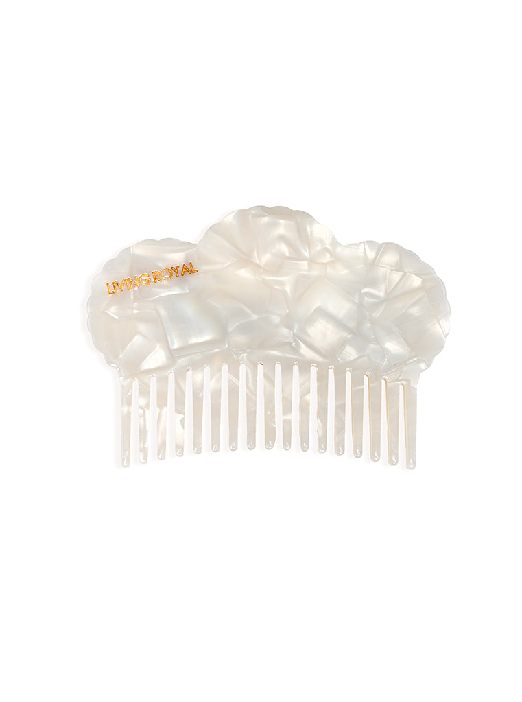 Hair comb featuring a seashell design, displayed on a white background.