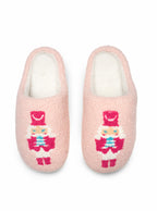 Cozy pink slippers featuring a nutcracker print, displayed against a clean white background.