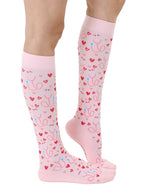 Pink padded compression socks featuring a stethoscope and hearts pattern, shown worn on a white background.
