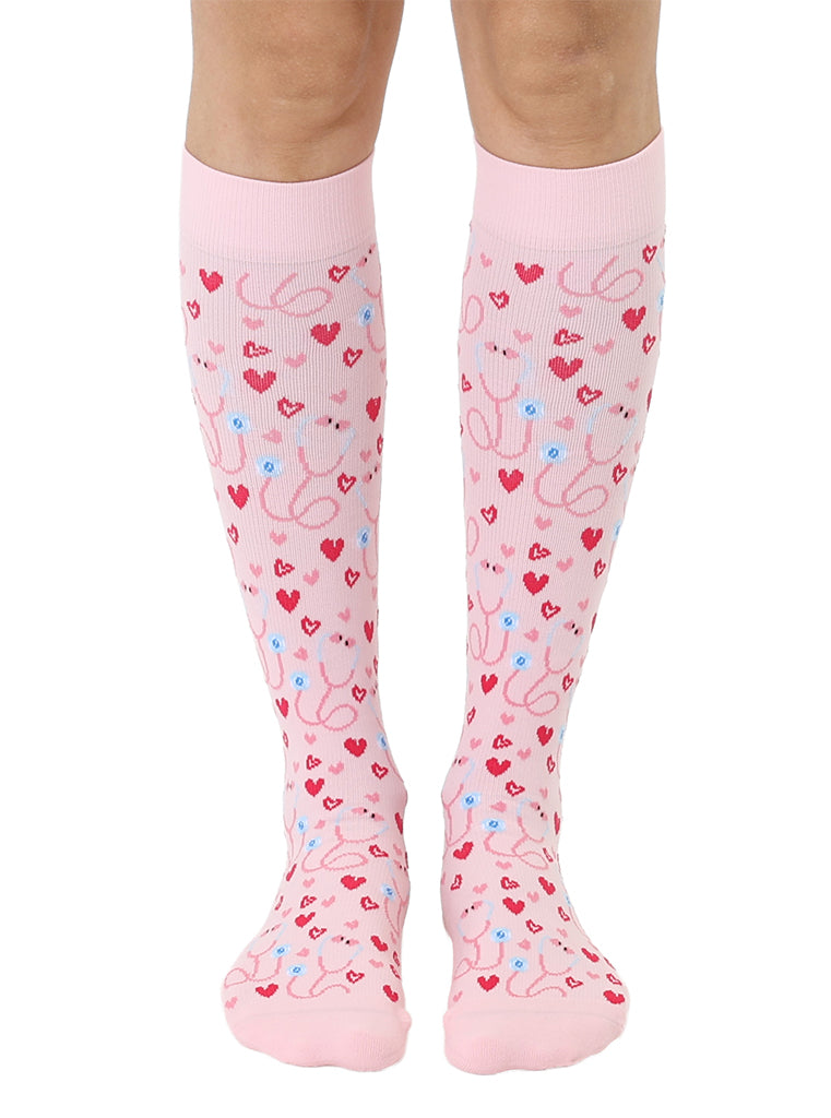 Pink padded compression socks featuring a stethoscope and hearts pattern, shown worn on a white background.