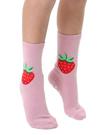 Pink socks with strawberry print worn by a person on a white background
