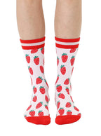 Red and light pink women’s bamboo crew socks featuring a strawberry-themed pattern, shown worn on a person against a white background.