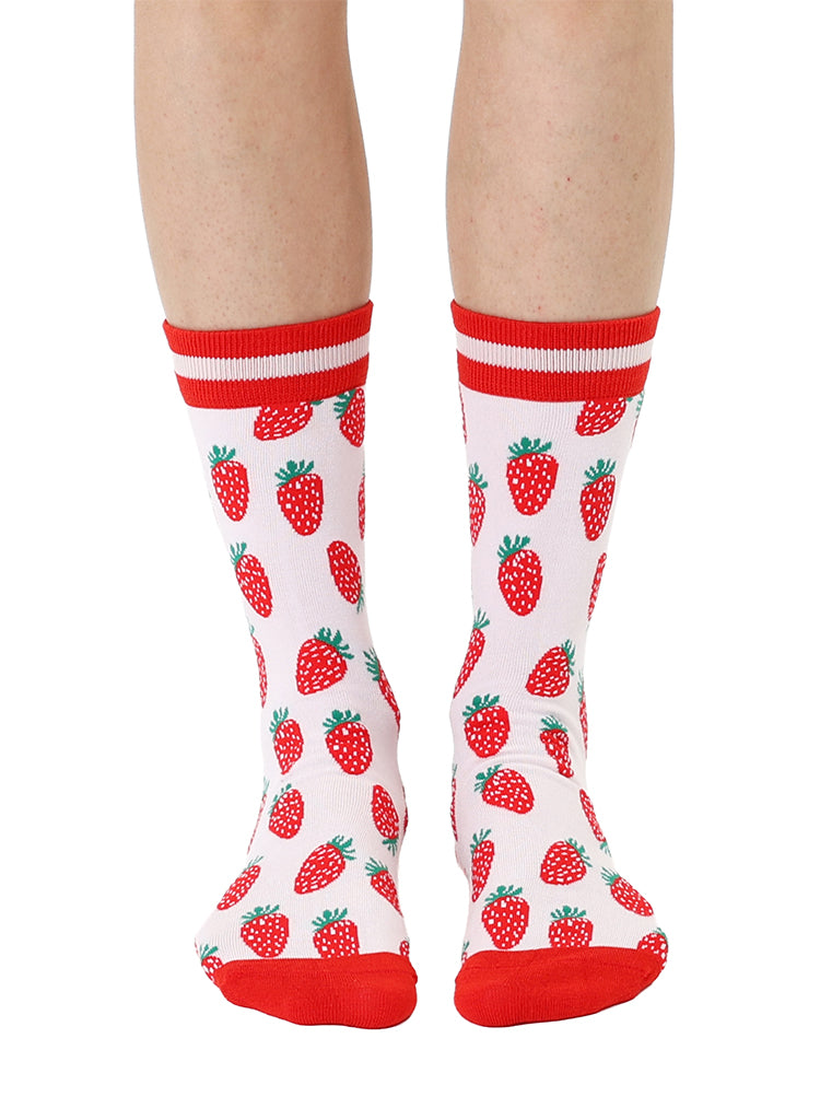 Red and light pink women’s bamboo crew socks featuring a strawberry-themed pattern, shown worn on a person against a white background.