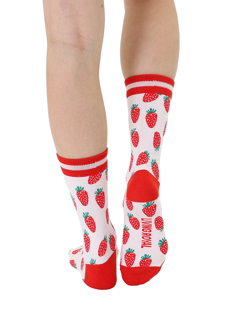 Red and light pink women’s bamboo crew socks featuring a strawberry-themed pattern, shown worn on a person against a white background.
