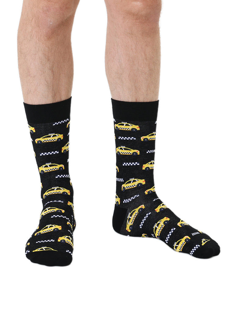 Black men’s bamboo crew socks with a yellow taxi print, worn on a white background.