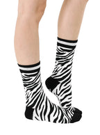 Women’s bamboo crew socks with a zebra print pattern, shown worn on a person against a white background.