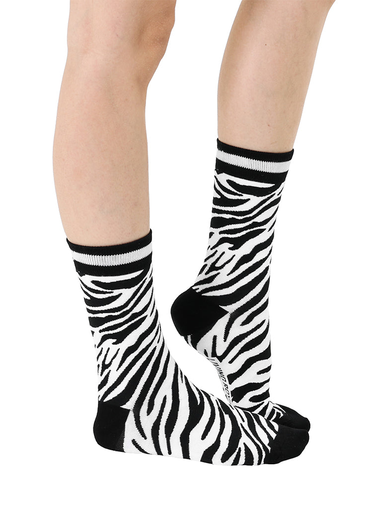 Women’s bamboo crew socks with a zebra print pattern, shown worn on a person against a white background.