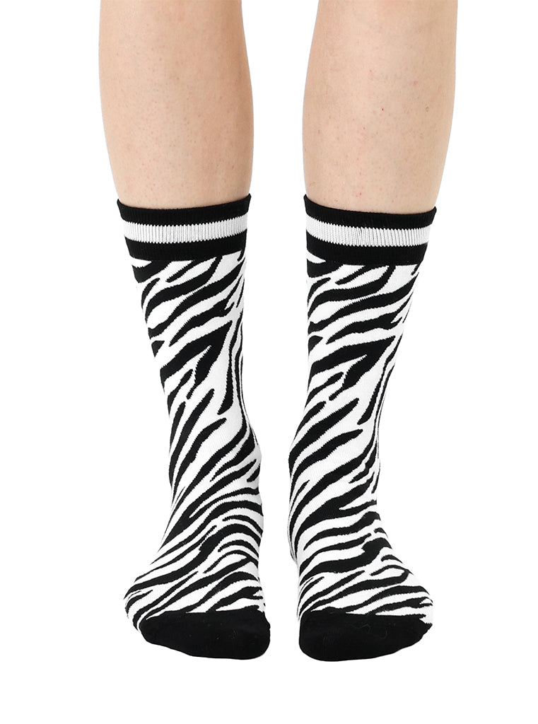 Women’s bamboo crew socks with a zebra print pattern, shown worn on a person against a white background.