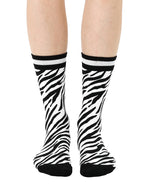 Women’s bamboo crew socks with a zebra print pattern, shown worn on a person against a white background.